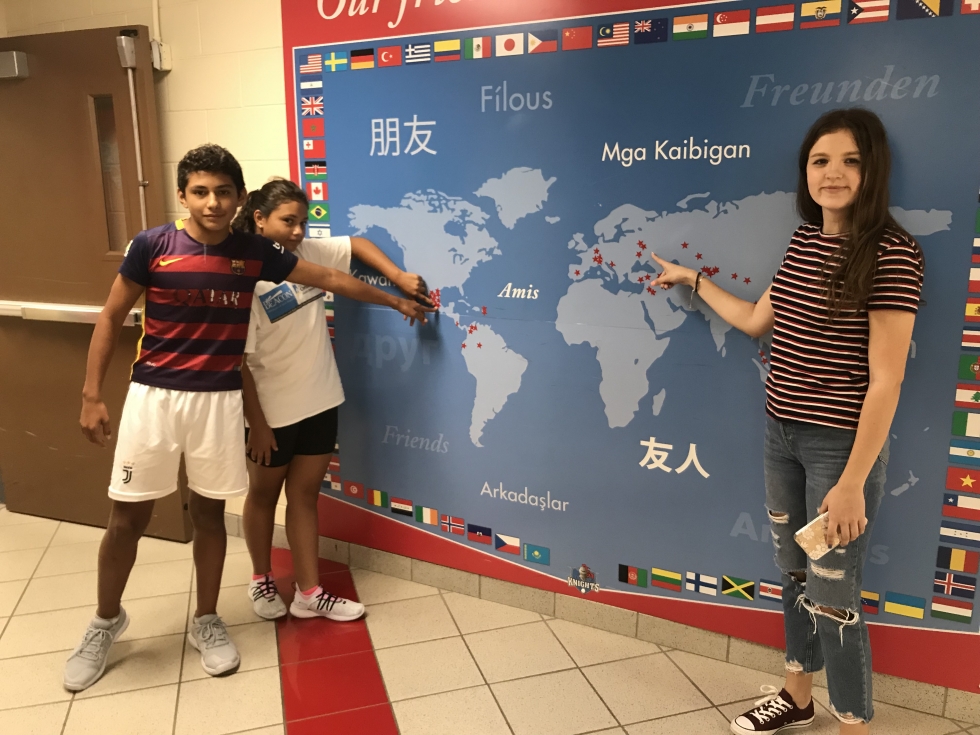 ESL students pointing to their country on a map